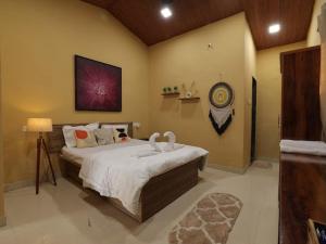 a bedroom with a large bed in a room at Veranda hillside retreat in Kharakvasla