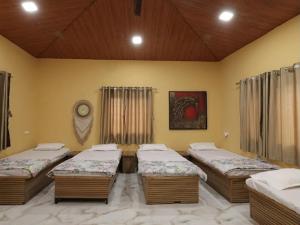 a room with four beds in a room at Veranda hillside retreat in Kharakvasla +16 photos