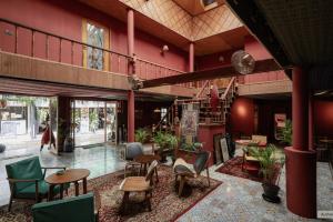 a room with chairs and tables in a building at Ḥokma Boutique Hotel & Tropical Lounge in Phi Phi Islands