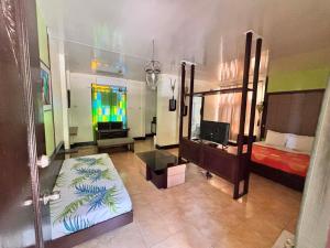 a bedroom with a bed and a tv in a room at La Traviesa Hotel Resort in General Trias