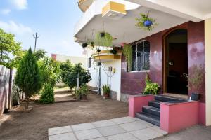a house with a red and white at Samarth Villa in Akalkot