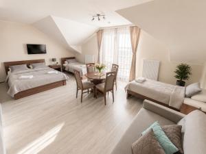 a bedroom with two beds and a living room at Villa Martii - Pokoje Rodzinne z Aneksami in Władysławowo +43 photos