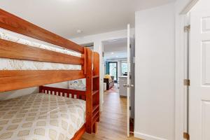 a bedroom with two bunk beds and a hallway at Windsor Hill Condo in Waterville Valley