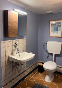 a bathroom with a white sink and a toilet at Mia's Atelier in Kamária
