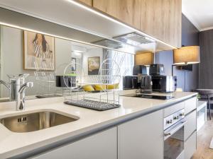 a kitchen with a sink and a counter at Lux @ Ellipse Galelileo in Midrand +277 photos