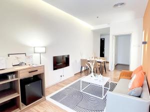 a living room with a couch and a table at Bangsar Trade Centre By WeCare in Kuala Lumpur
