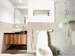 a bathroom with a toilet and a sink at Bangsar Trade Centre By WeCare in Kuala Lumpur