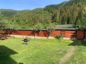 a bird standing in the grass in front of a fence at Садиба VAKO in Verkhniy Bystryy