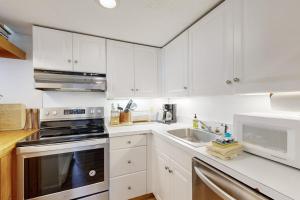 a white kitchen with white cabinets and a sink at Moon River Lodge in Lincoln