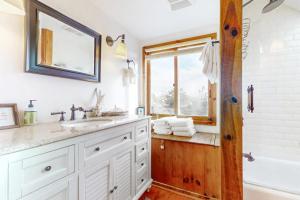 a bathroom with a sink and a tub and a window at Audrey Leigh in Newburyport +43 photos
