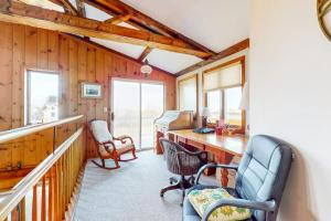 a home office with a desk and chairs and windows at Audrey Leigh in Newburyport