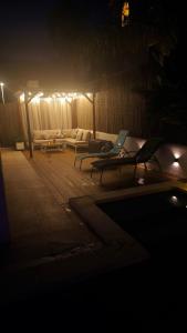a dark room with a couch and a table with a laptop at Sitges Casablanca in Sant Pere de Ribes