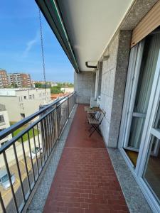 a balcony with a table and benches on a building at Morivione Apartment - Bocconi free parking in Milan