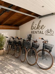 a row of bikes parked in front of a bike rental sign at Rolly - Rooms & Restaurant in Riva del Garda