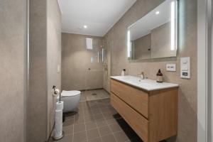 a bathroom with a sink and a toilet at Olden Fjord View in Olden +20 photos