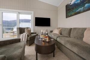 a living room with a couch and a table at Olden Fjord View in Olden