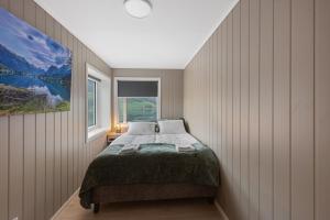 a bedroom with a bed and a window at Olden Fjord View in Olden