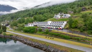 a building on a hill next to a river at Olden Fjord View in Olden