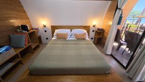 a bedroom with two beds in a room at Kubotique Beachfront Staycation in El Nido
