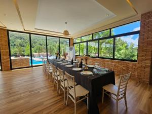 a long dining room with a long table and chairs at Serenata Korcare Resort in Tirana +93 photos