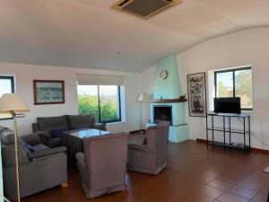 a living room with a couch and a table and a tv at Cortijo Majada de las Vacas in Santa Olalla del Cala