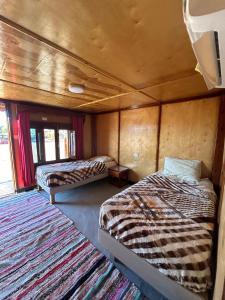 a room with two beds and two rugs at Free Beach Camp in Nuweiba‘ el Muzeinah +46 photos