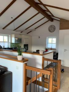 a kitchen with a bar and a clock on the wall at Chalet im Chiemgau in Siegsdorf