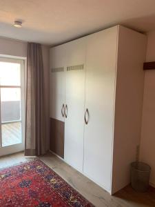 a large white cabinet in a room with a window at Chalet im Chiemgau in Siegsdorf