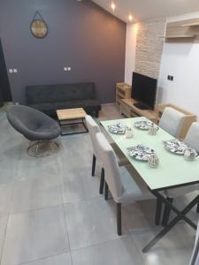 a living room with a table and chairs and a couch at Nature et calme d'Angers in Saint-Martin-du-Fouilloux +8 photos