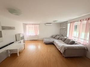 a living room with a large couch in the middle at Villa Kraker in Muta