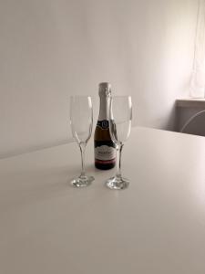 a bottle of wine and two wine glasses on a table at Villa Kraker in Muta