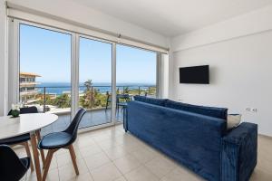 a living room with a couch and a table at Celestial Luxury Residences in Asgourou