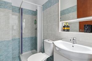 a bathroom with a toilet and a sink and a shower at Celestial Luxury Residences in Asgourou +5 photos