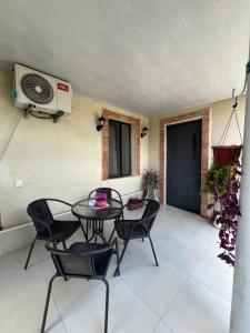 a patio with a table and chairs and a fan at garden and panorama in Mtskheta +33 photos