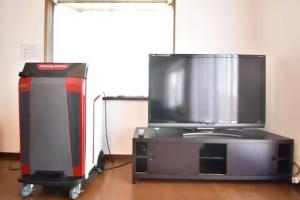 a tv sitting on top of a entertainment center at Sunrise Resort Aji in Takamatsu