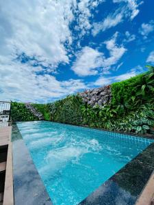 a swimming pool with a blue sky in the background at Eliana Robusta Hotel in Hanoi