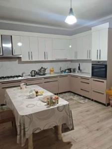 a kitchen with a table in the middle of it at Minsu in Mamyr
