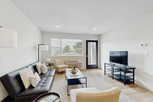 a living room with a couch and a table at Mod Haus 1 in Kalispell