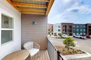 a balcony with two chairs and a view of a street at Mod Haus 1 in Kalispell