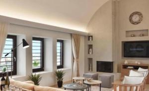 a living room with a couch and a tv at Maison Palms in Mesaria