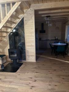a living room with a woodburning stove in a cabin at Gruszchatka 1 in Gruszów +4 photos
