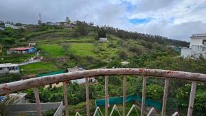 a view of a hill with a house on it at Vedhas Holidays in Kodaikānāl