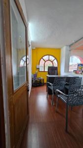 a room with a table and chairs and a door at Vedhas Holidays in Kodaikānāl
