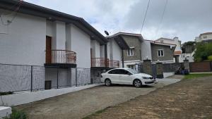 a white car parked in front of a house at Vedhas Holidays in Kodaikānāl +15 photos