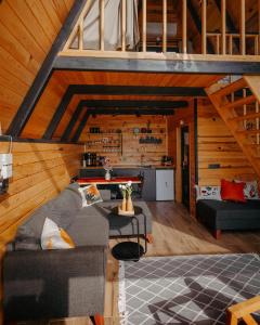 a living room with a couch and a table at Koda Bungalov in Ardeşen