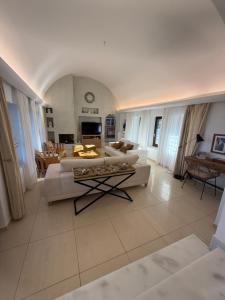 a large living room with couches and a table at Maison Palms in Mesaria +72 photos