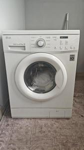 a white washing machine sitting in a room at Minsu in Mamyr