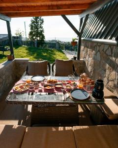 a table with plates of food on a patio at Koda Bungalov in Ardeşen