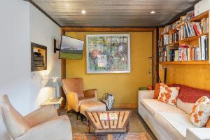 a living room with a couch and chairs and a book shelf at Galena Chalet - Valley View 1 Br 1 Ba 2 Half Ba Sleeps 4 in Telluride