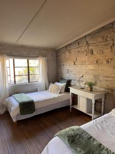 a bedroom with two beds and a window at From Valle Hideaway in Tankwa in Sutherland